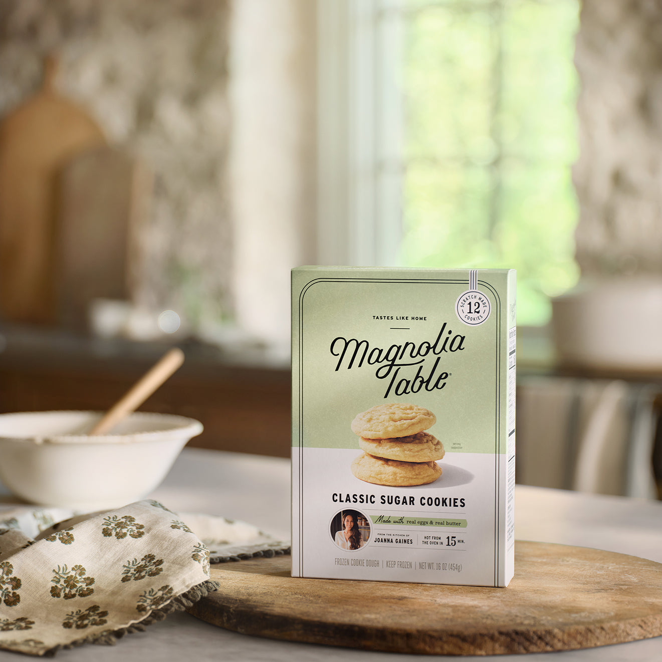 Box of Frozen Magnolia Table Classic Sugar Cookies on a kitchen counter with a blurred background.