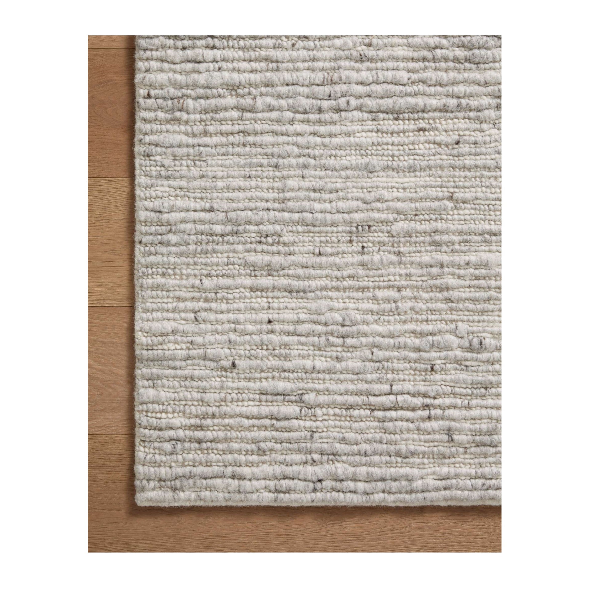 Ava Grey Ivory Rug close up on wood floor
