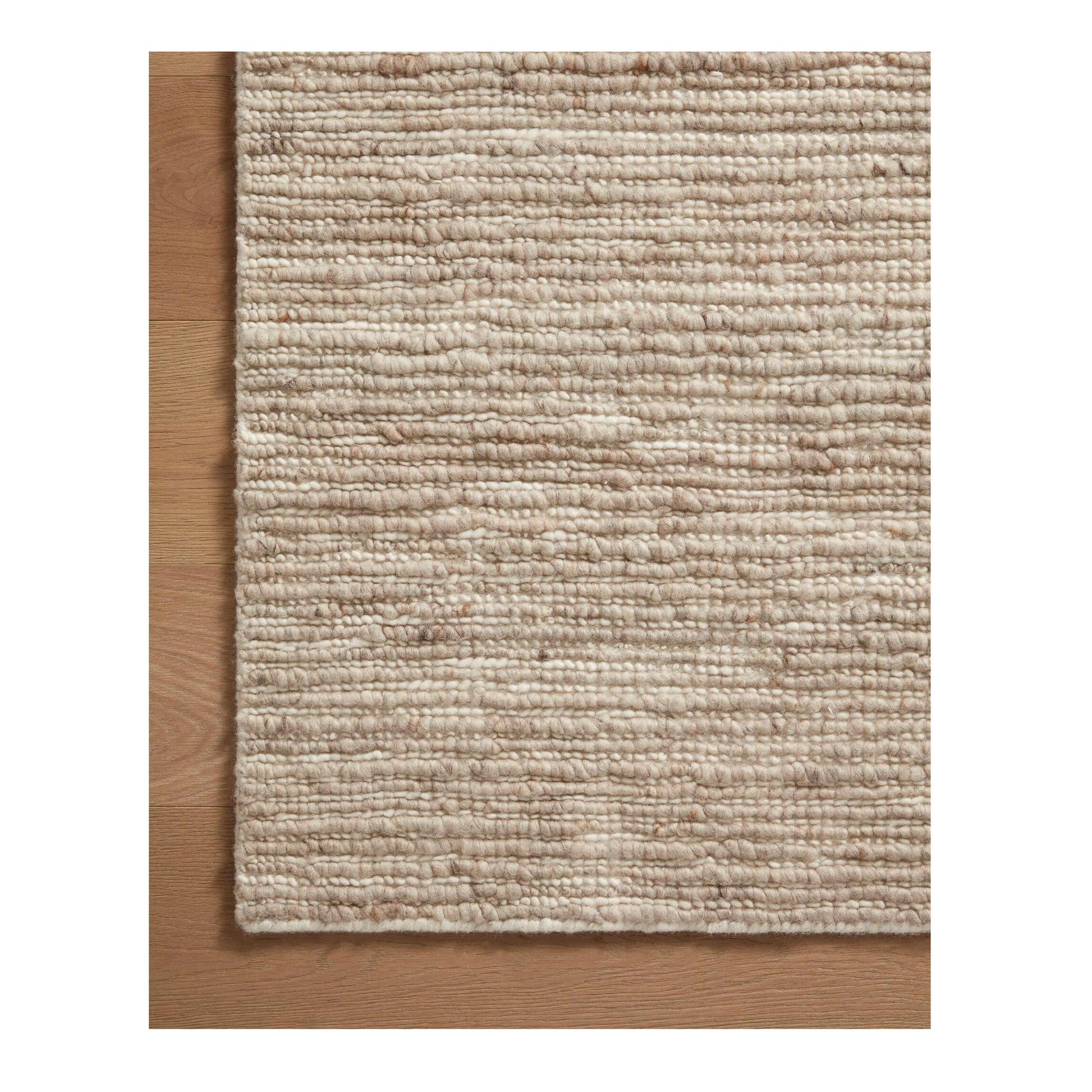 Ava Natural Ivory Rug close up of corner of rug on wood floor