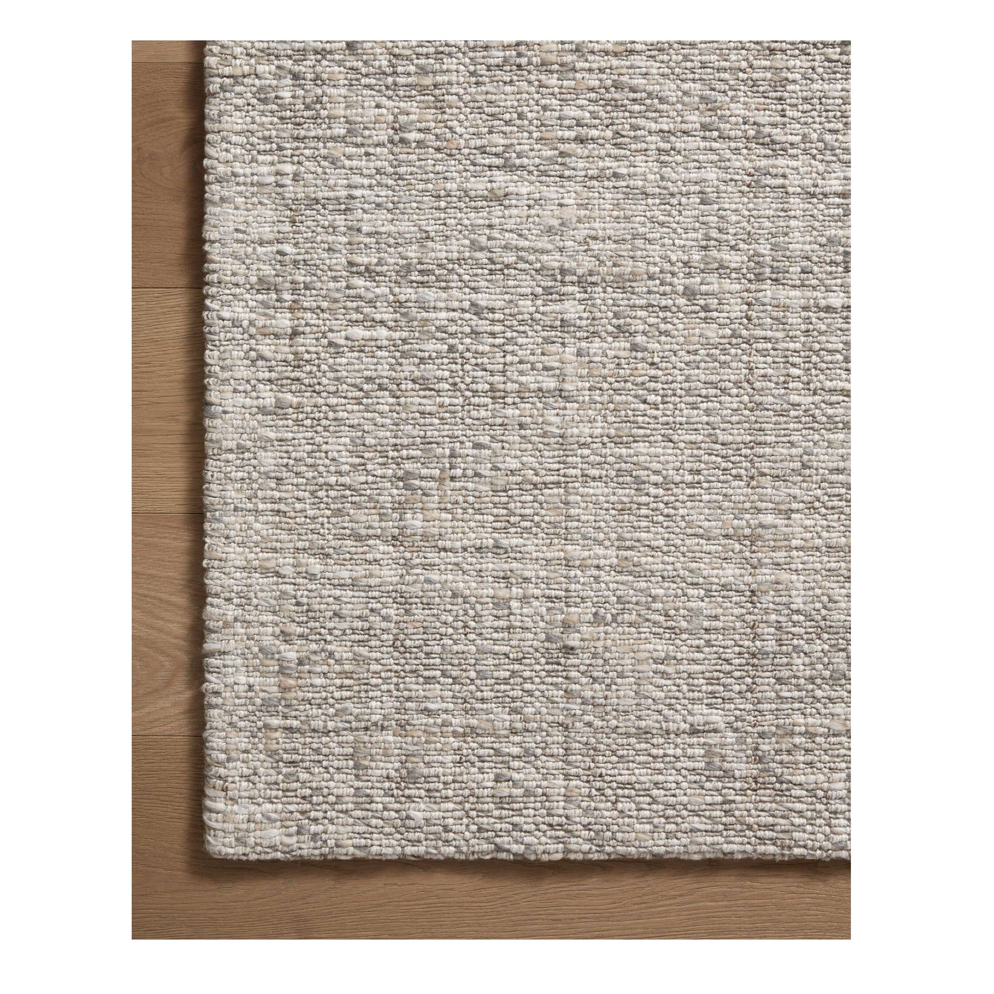 Pippa Silver Rug close up of corner on a wood floor