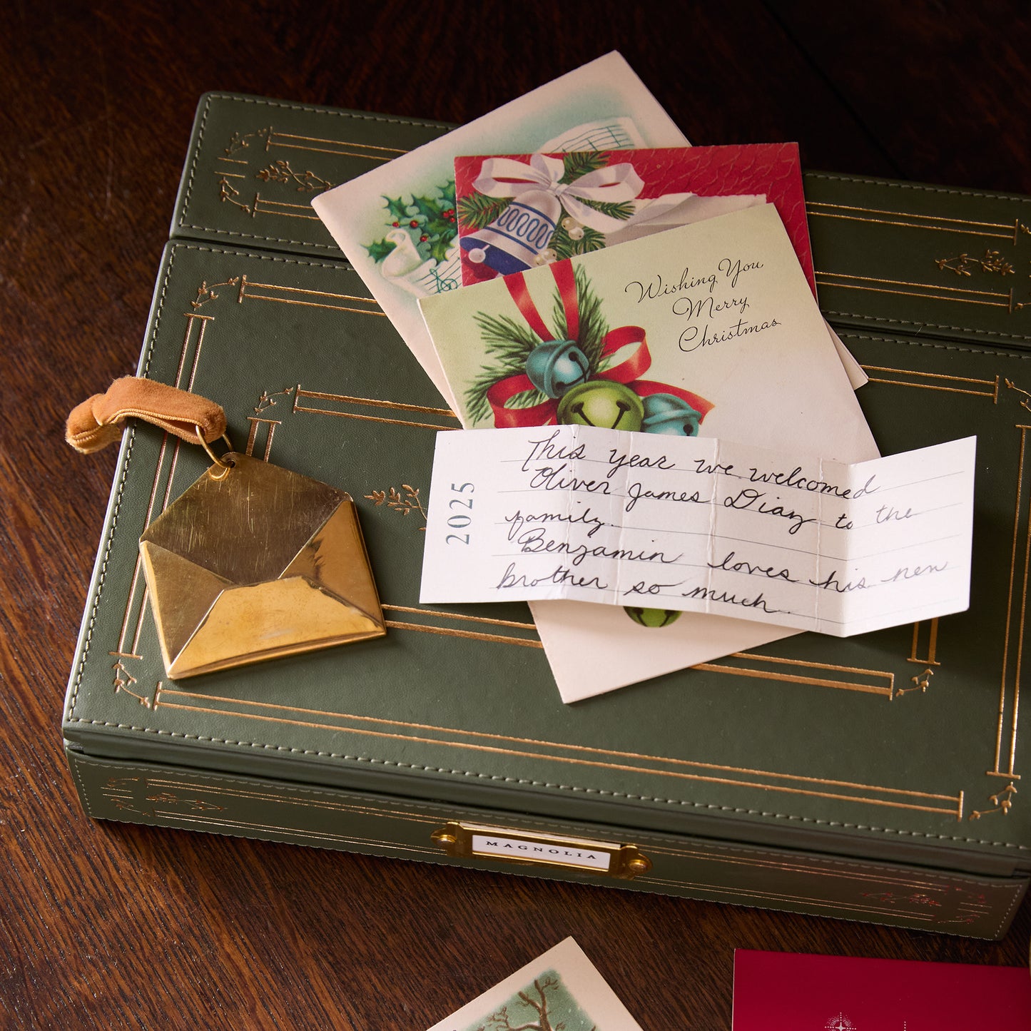 2025 Magnolia Brass Keepsake Envelope Ornament in use