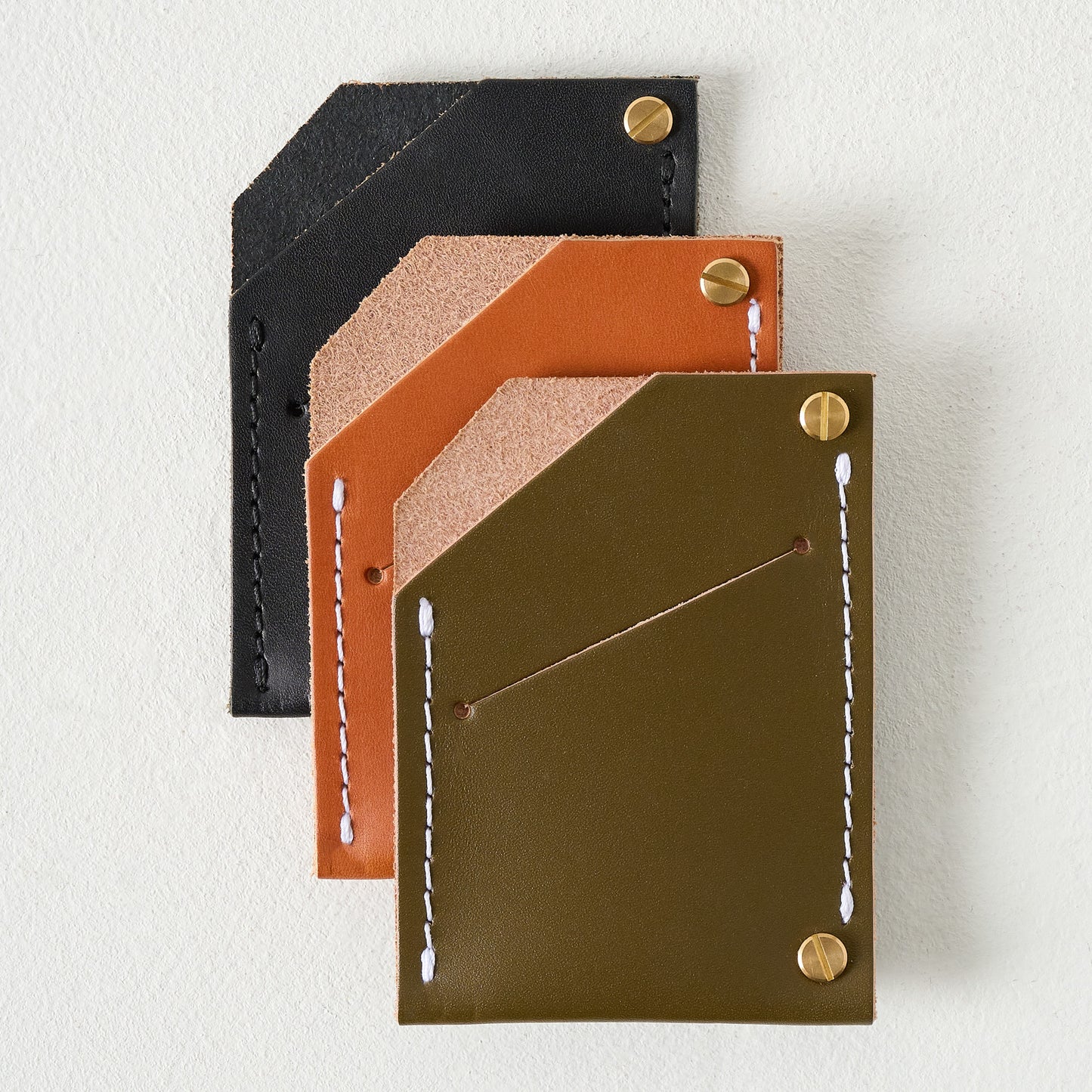 Olive Quebec Wallet shown with other wallets