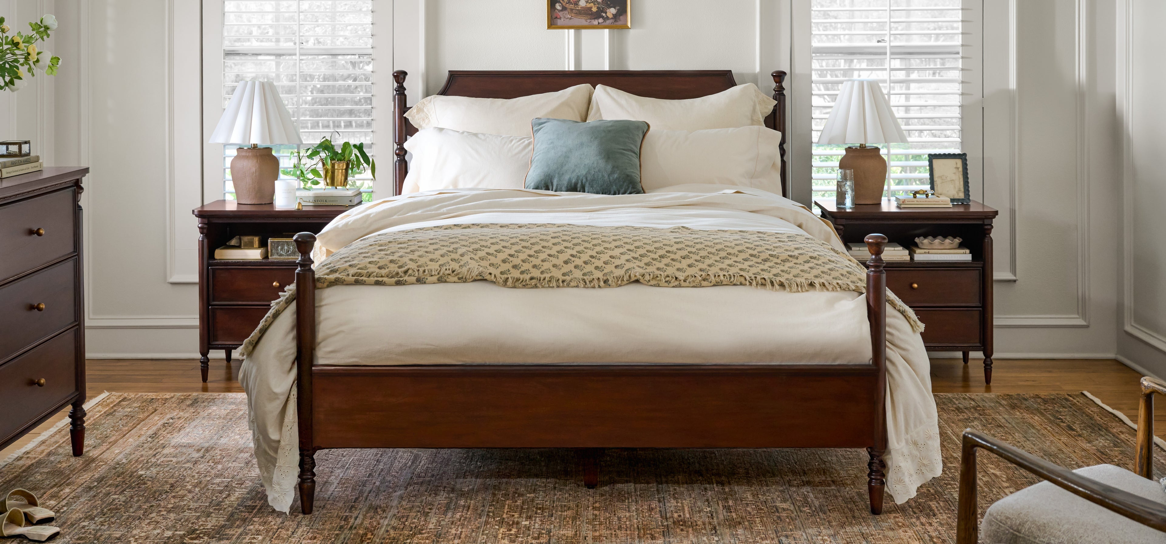 Wooden bed with white bedding in a bedroom setting
