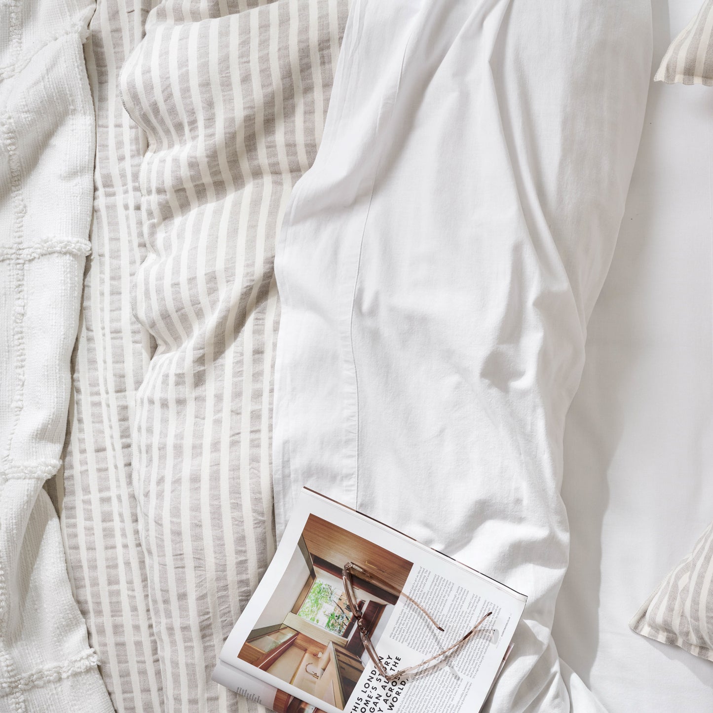 optic white textured cotton coverlet with a book on top