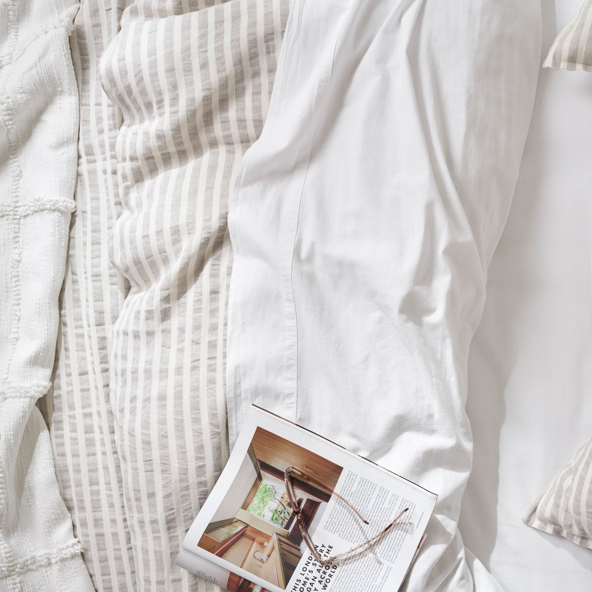 optic white textured cotton coverlet with a book on top