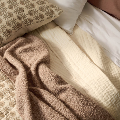 Flora Block Print Quilt - Natural on a bed