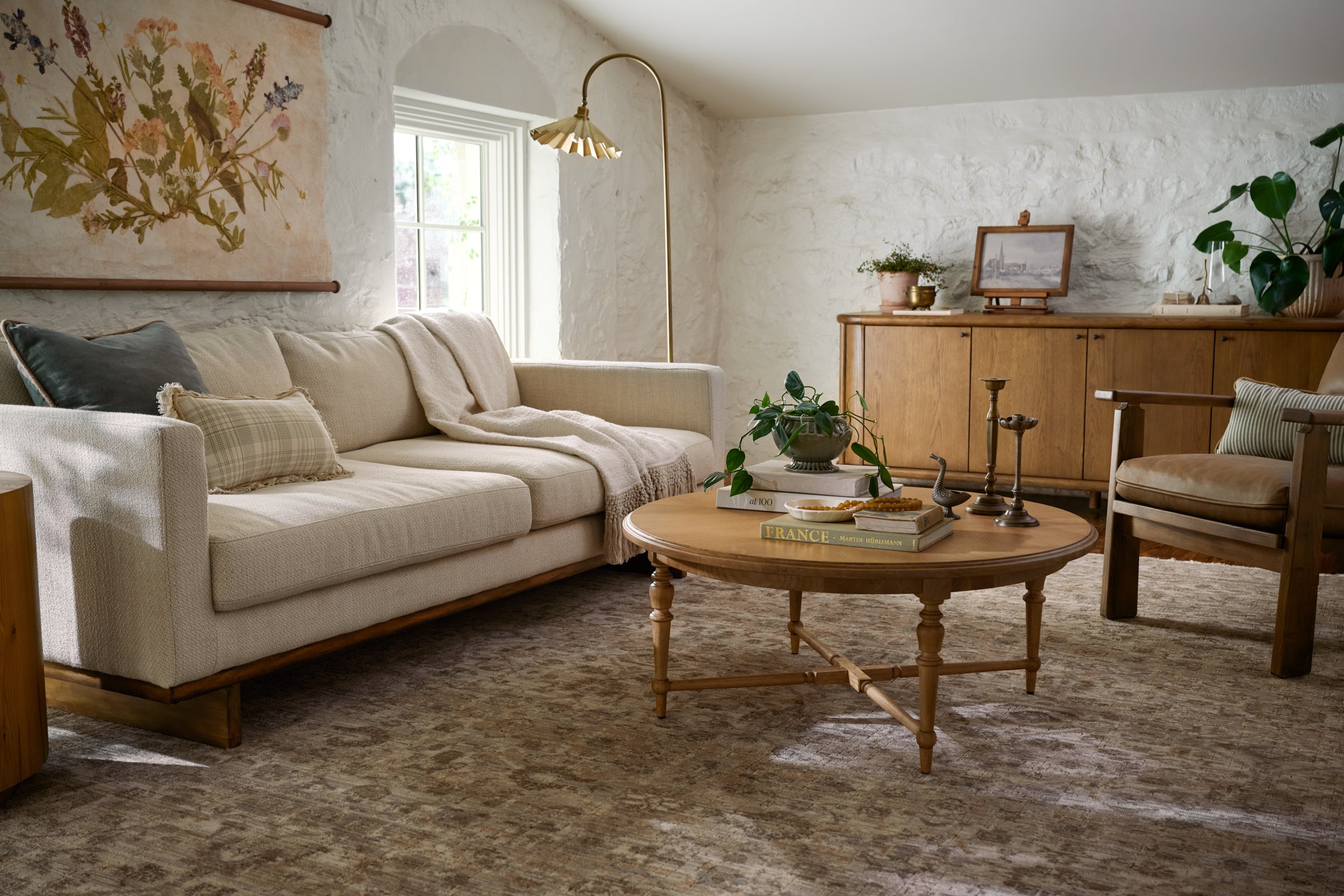 Living room with beige sofa, wooden coffee table, and decorative items.