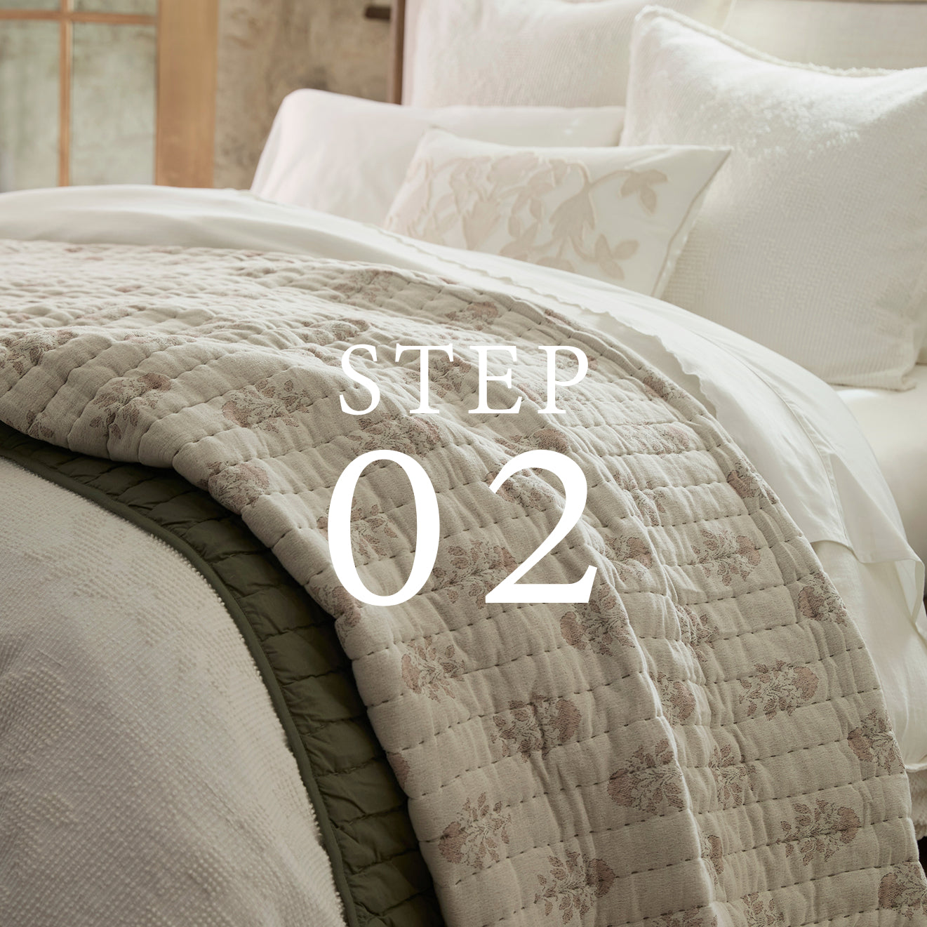 Quilted blanket on a bed with decorative pillows, featuring the text 'STEP 02'.