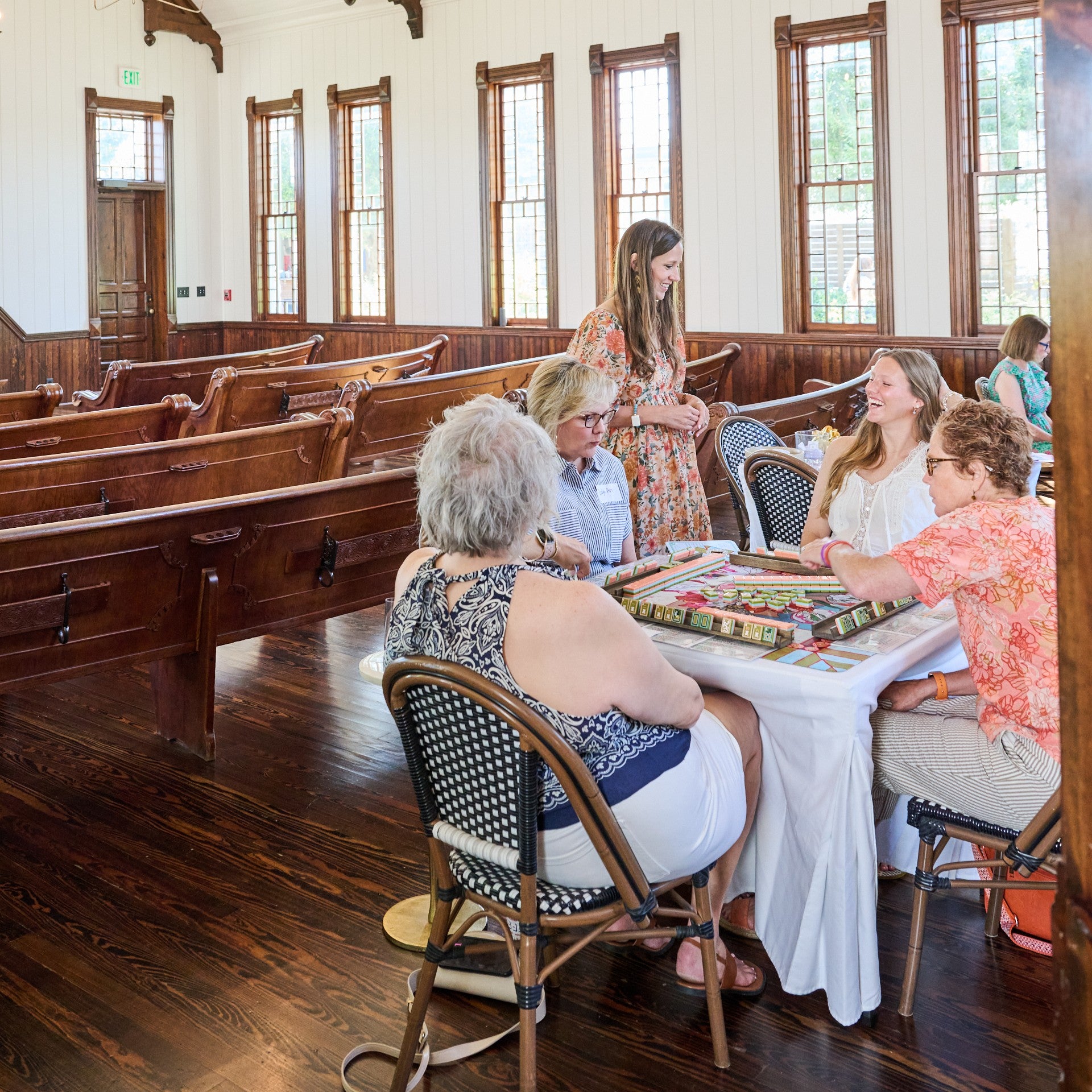 A group of women playing Mahjong in the Old Church on the Silos grounds.