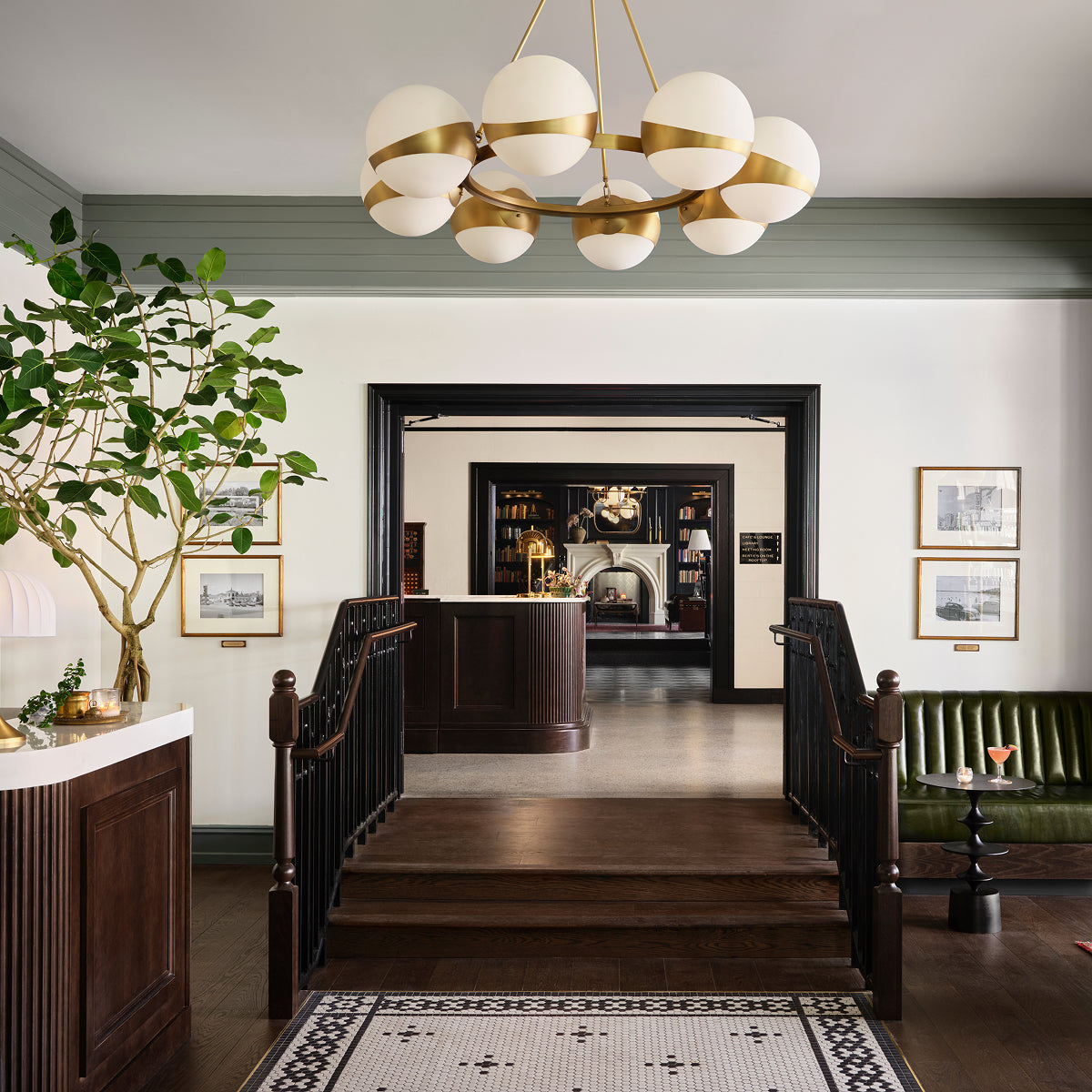 Luxurious interior of Hotel 1928 with a chandelier, staircase, and decorative elements.