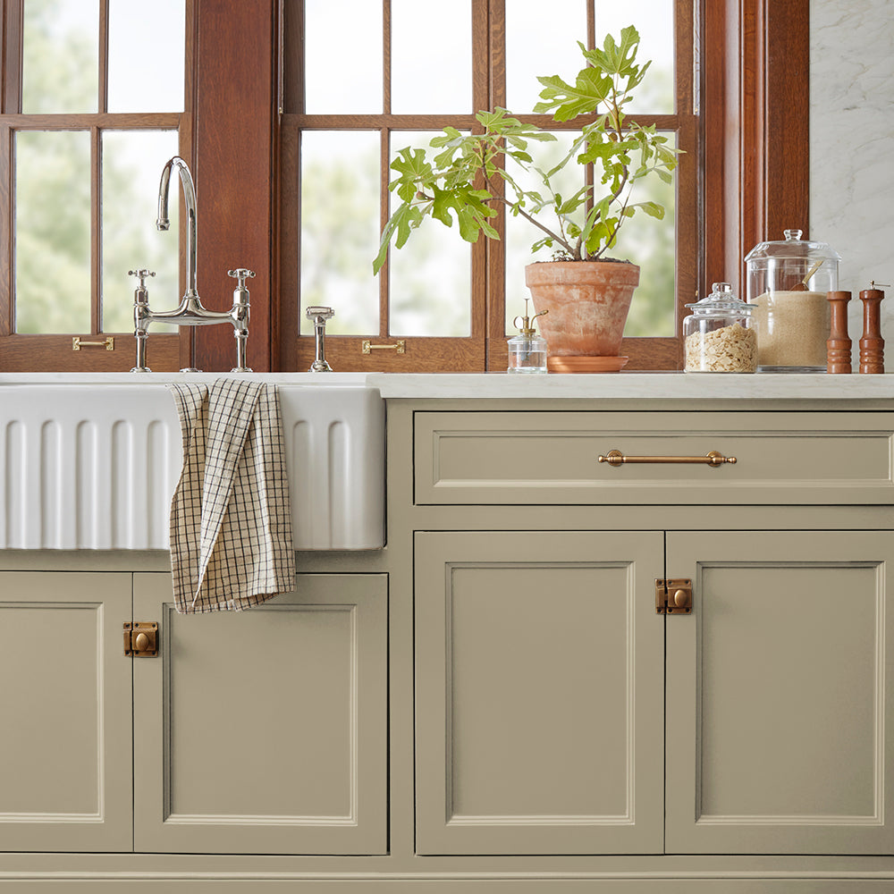 sunwashed green paint color named juniper tree shown painted on kitchen cabinet