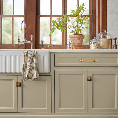 sunwashed green paint color named juniper tree shown painted on kitchen cabinet