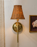 Rattan Plug-In Wall Sconce shown on wall with wall art