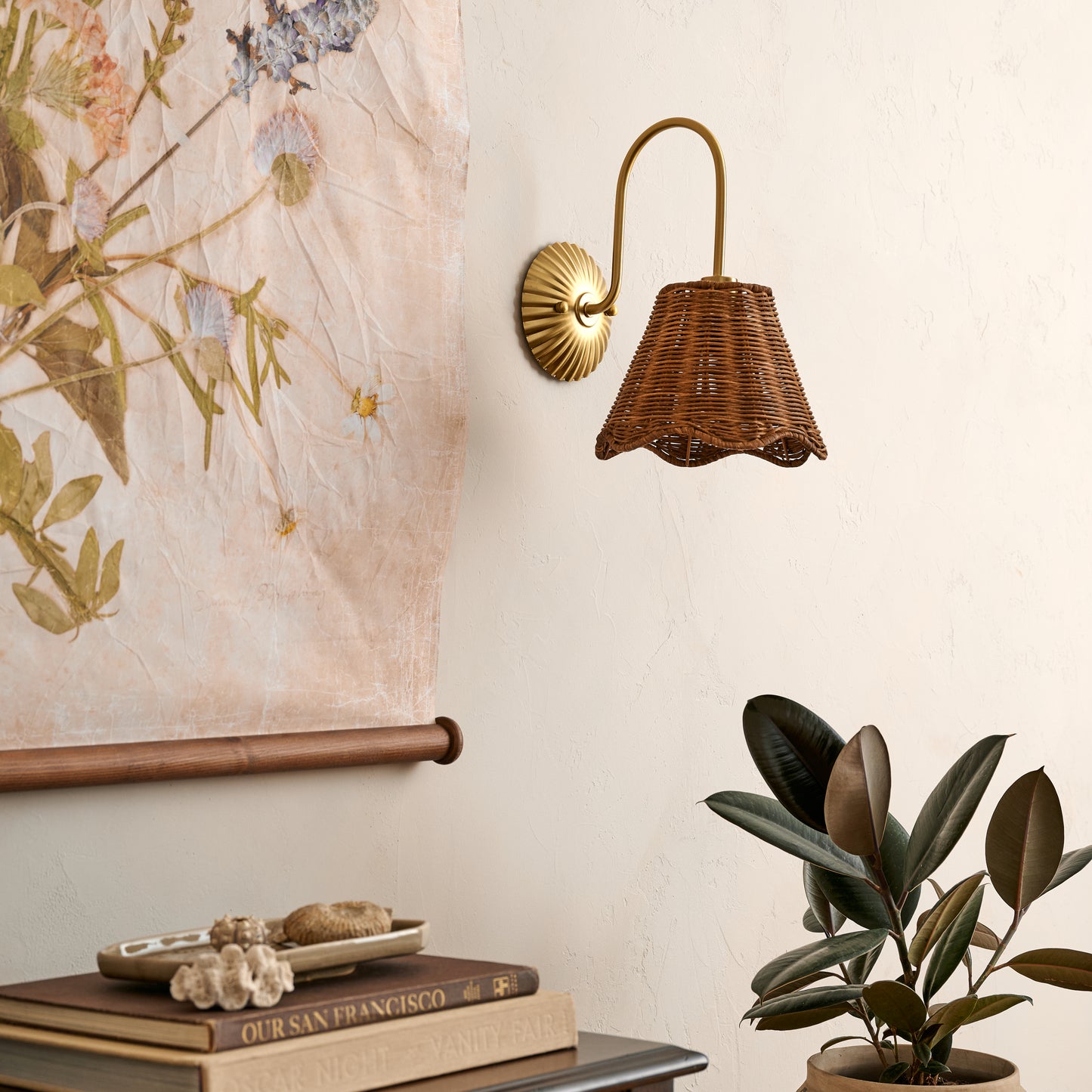 Lucinda Hardwired Wall Sconce in a room next to tapestry