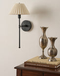 Elias Wired Sconce next to bud vases and nightstand