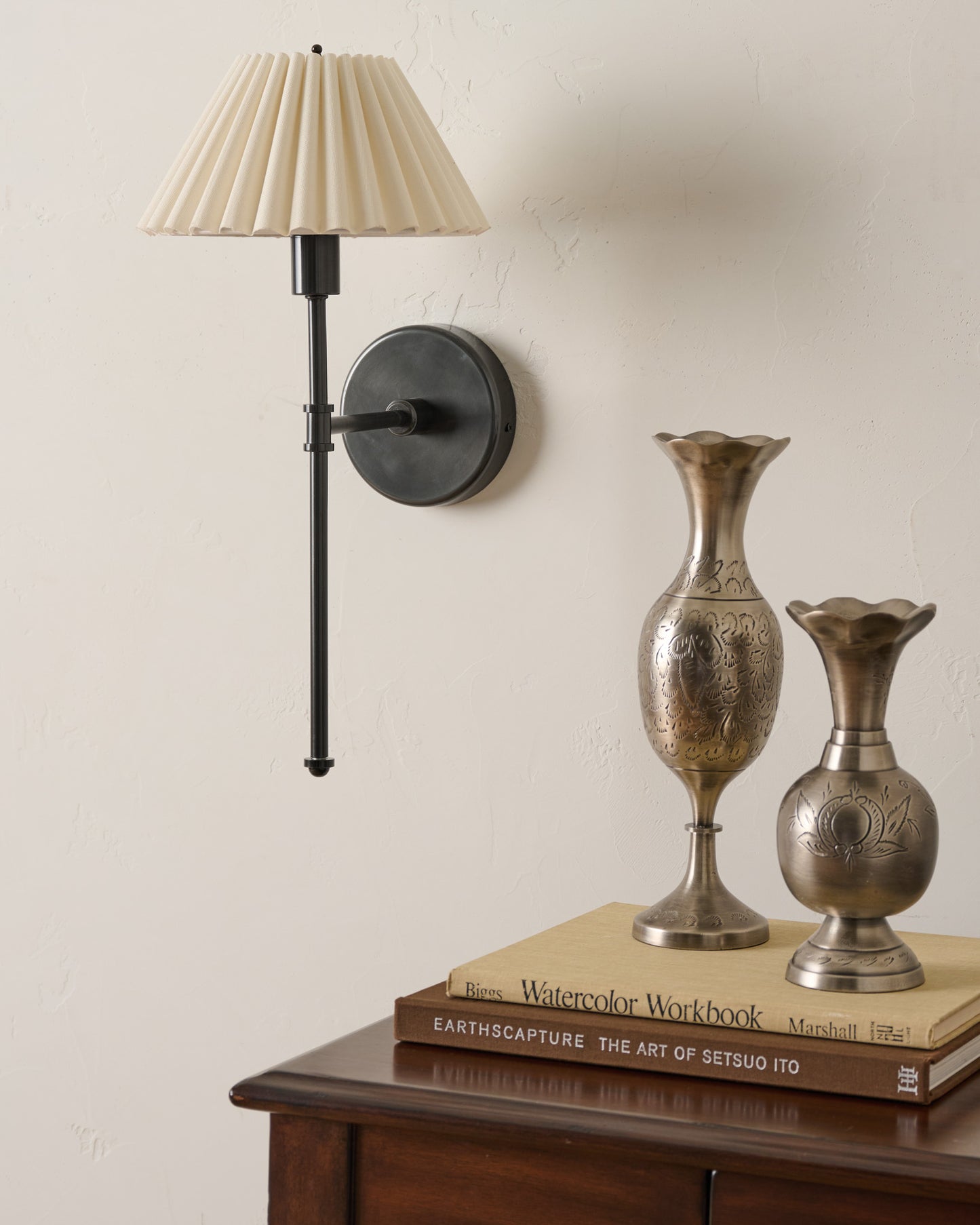Elias Wired Sconce next to bud vases and nightstand