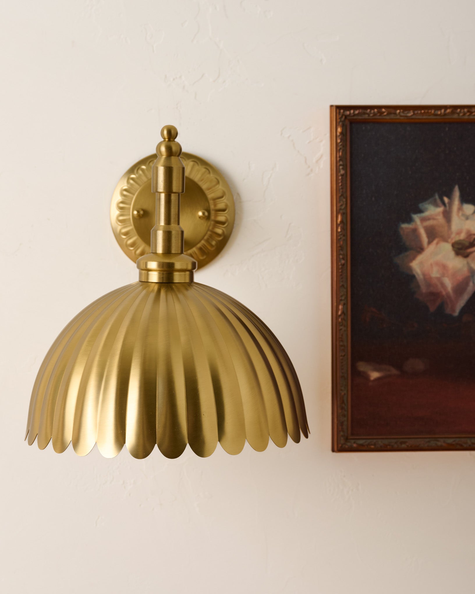 Callan Fluted Brass Wired Sconce next to wall art