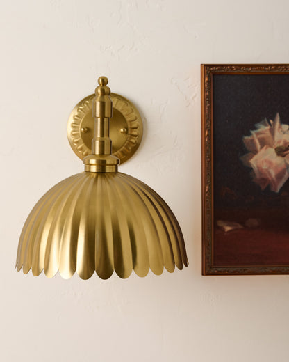 Callan Fluted Brass Wired Sconce next to wall art