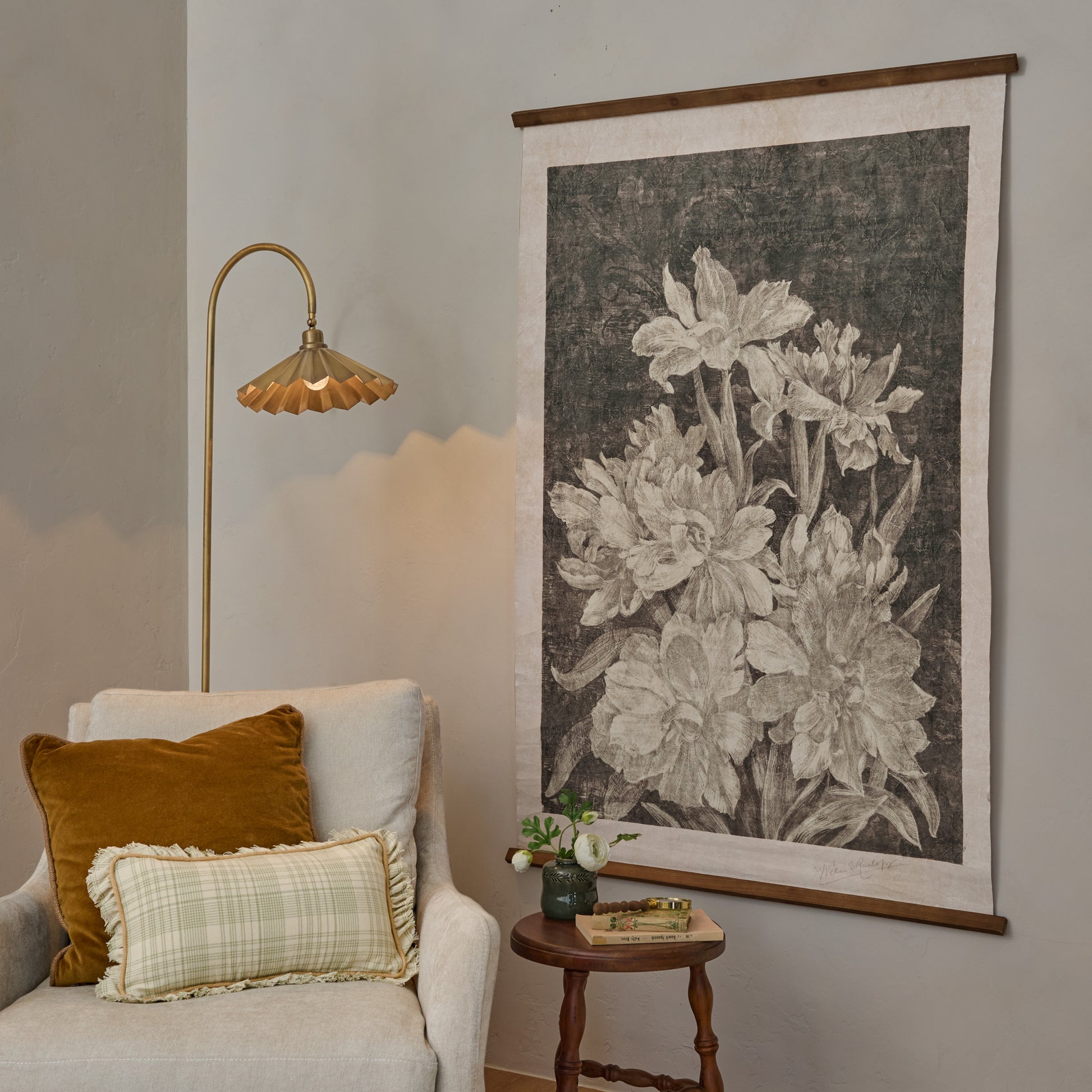 Vintage Bloom Sketch Tapestry in a room next to accent chair and brass pleated floor lamp