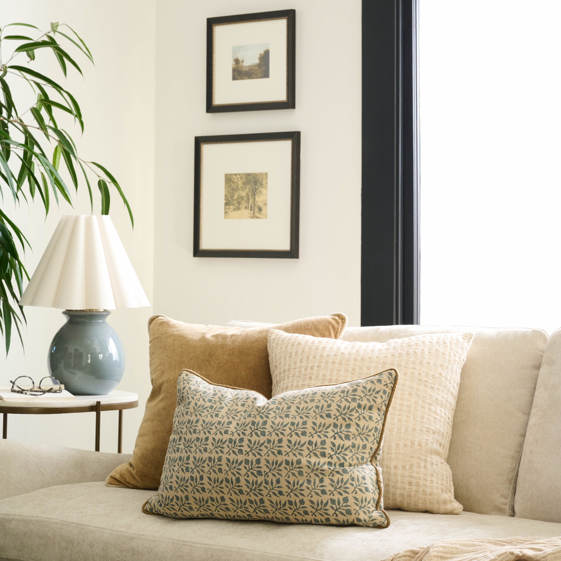Lucie Floral Printed Lumbar Pillow on a sofa with other throw pillows