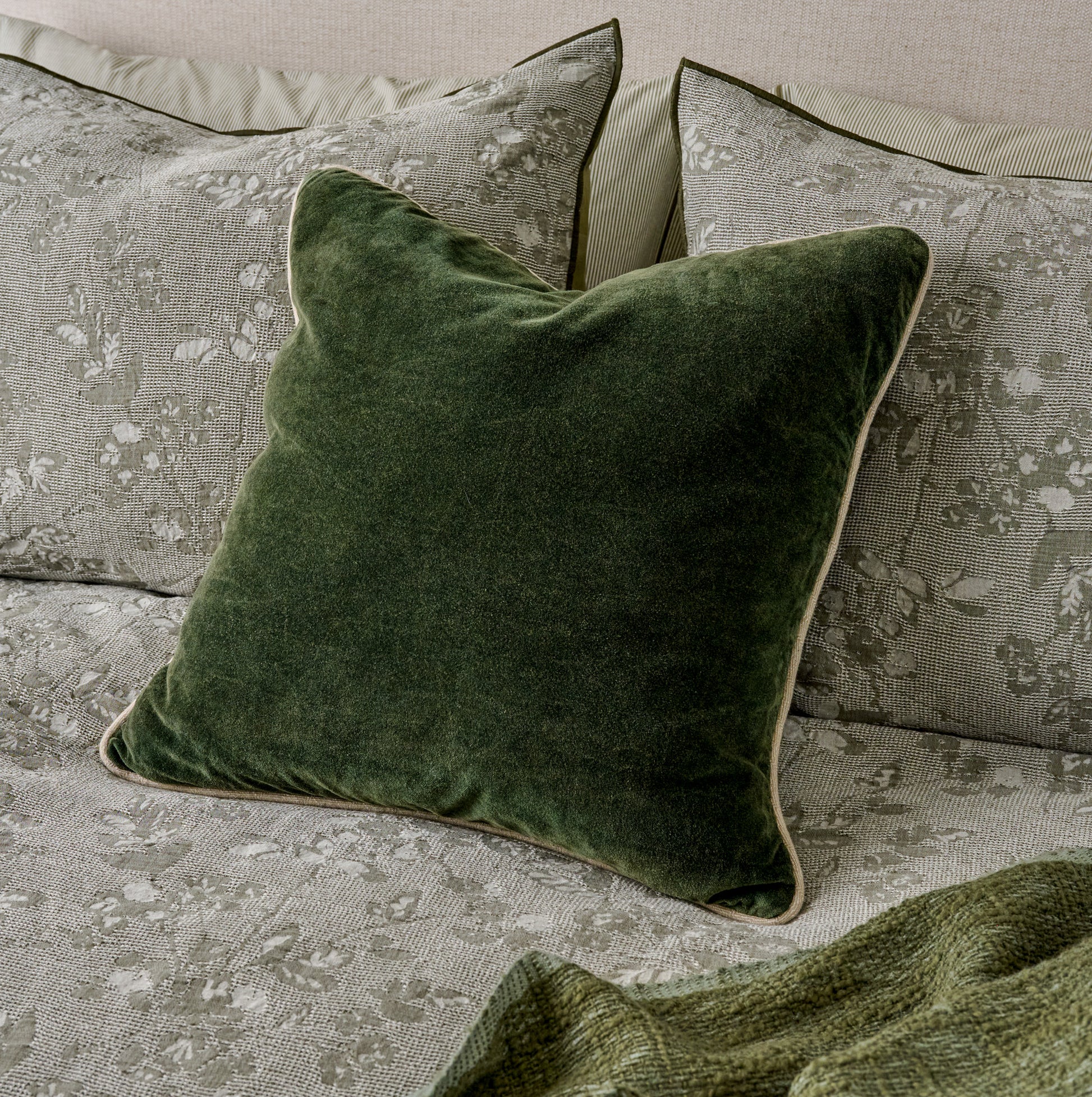 Heirloom Velvet Pillow - Forest Green shown on bed