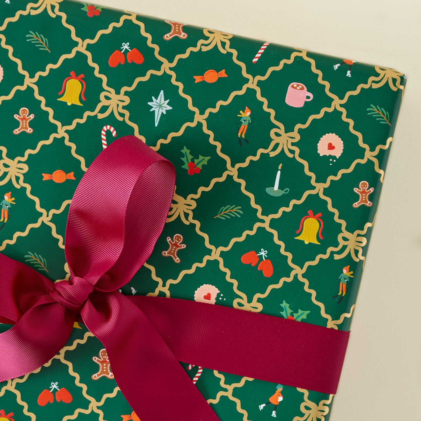 Holiday Argyle Continuous Wrapping Roll shown on gift with red ribbon