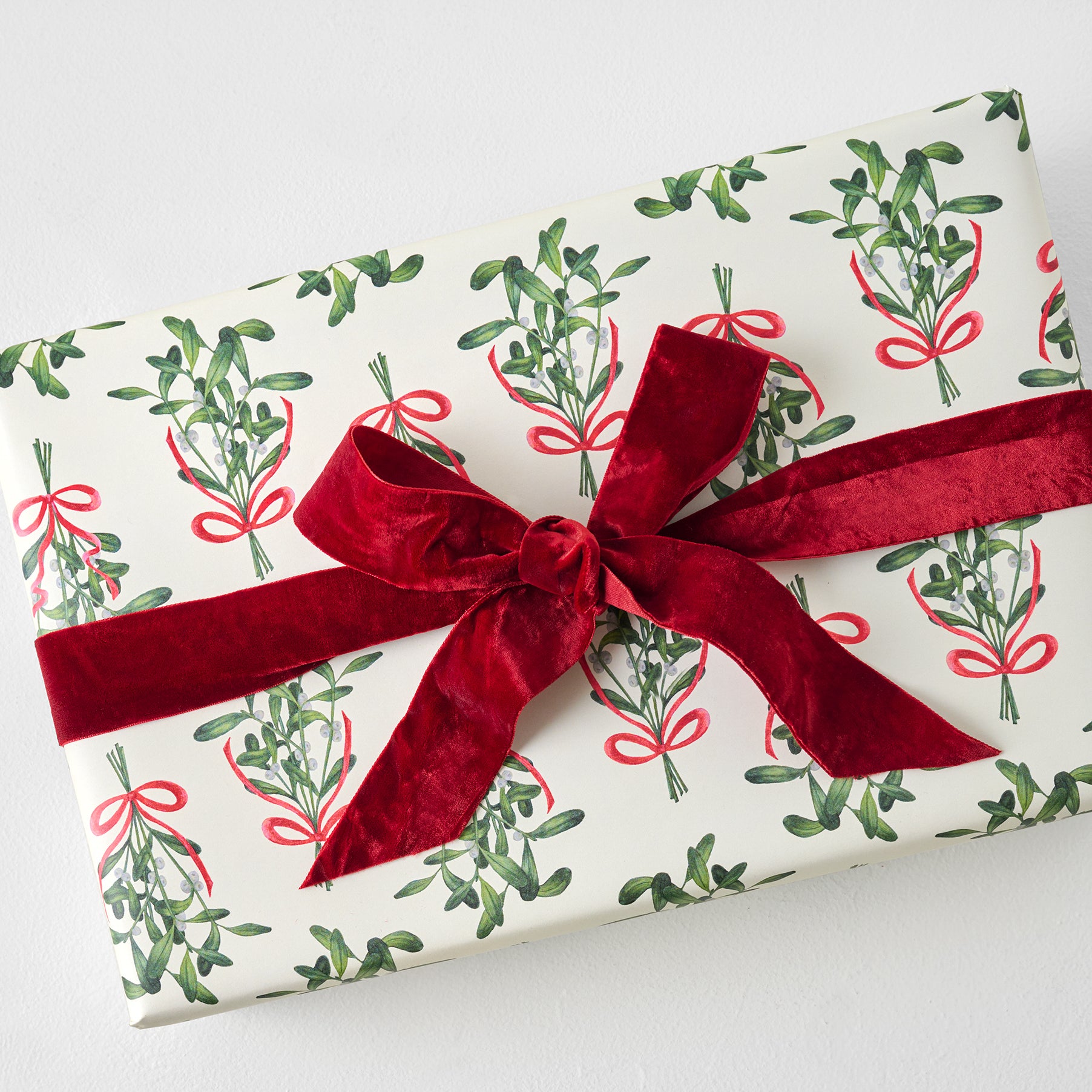 Mistletoe Classic Wrapping Paper Sheets shown on gift