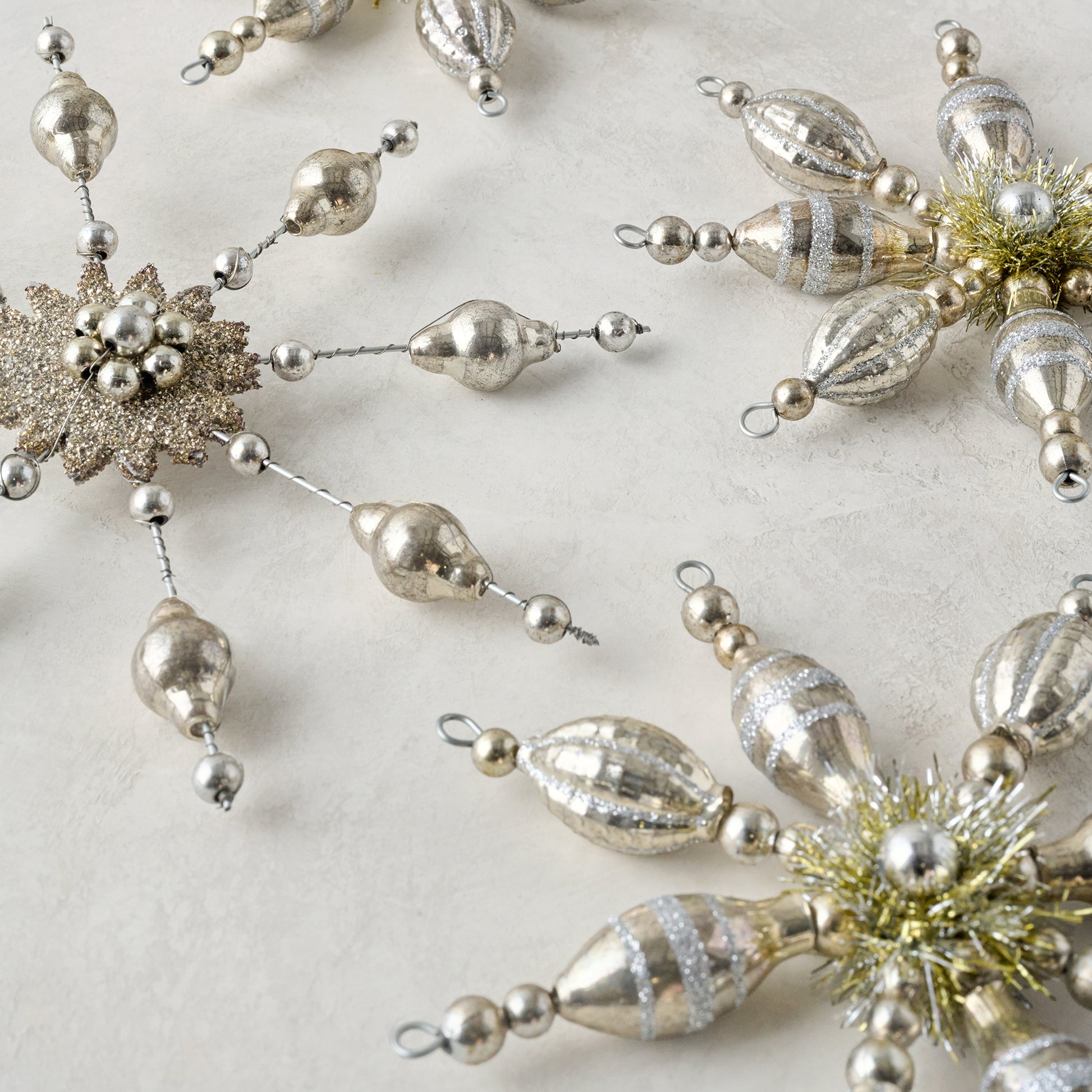 Mercury Glass Beaded Snowflake Ornament shown with other ornaments