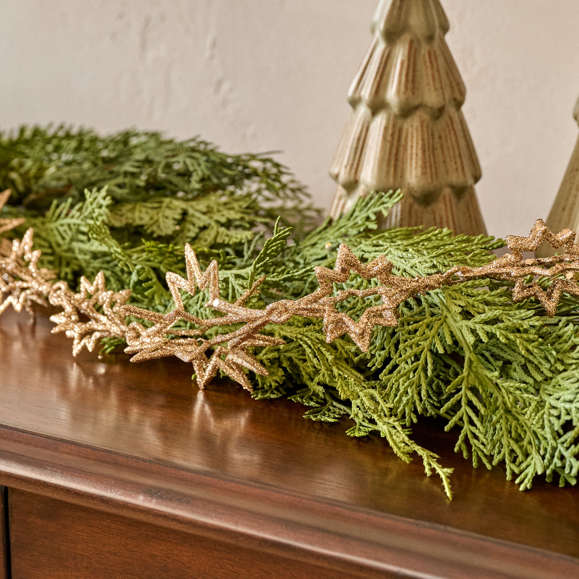 Stella Glimmer Garland shown with greenery