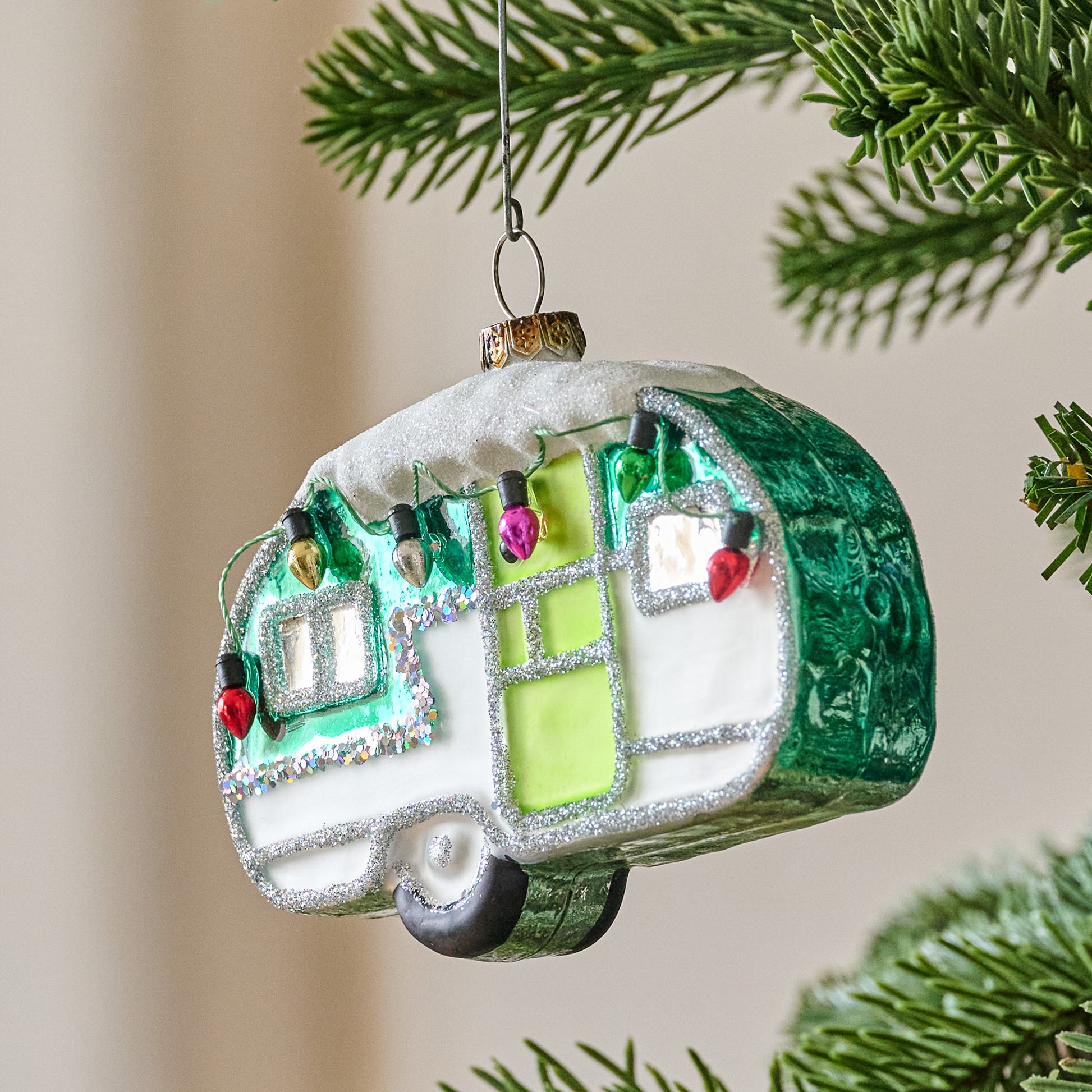 Retro Snowy Camper Ornament shown on tree