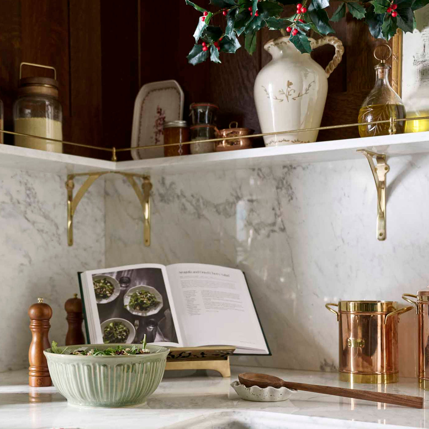 Kitchen counter with marble backsplash, cookbooks, and decorative items.