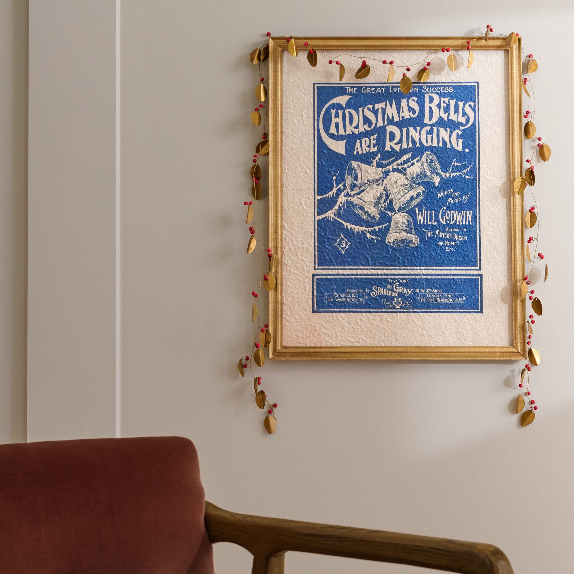 Vintage Christmas Bells Are Ringing Framed Print shown styled on wall with garland