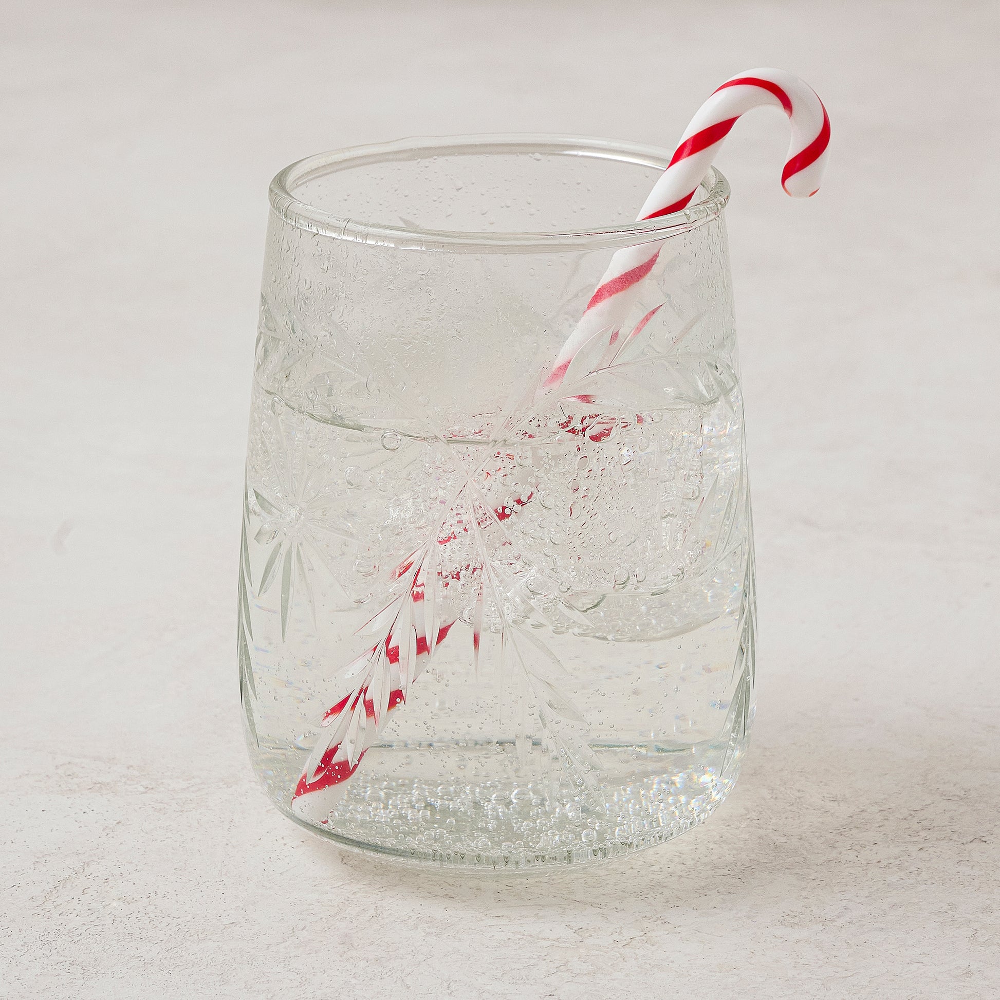 Candy Cane Cocktail Stirrer shown in glass with drink
