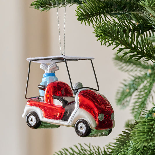 Glass Golf Cart Ornament shown hung from tree