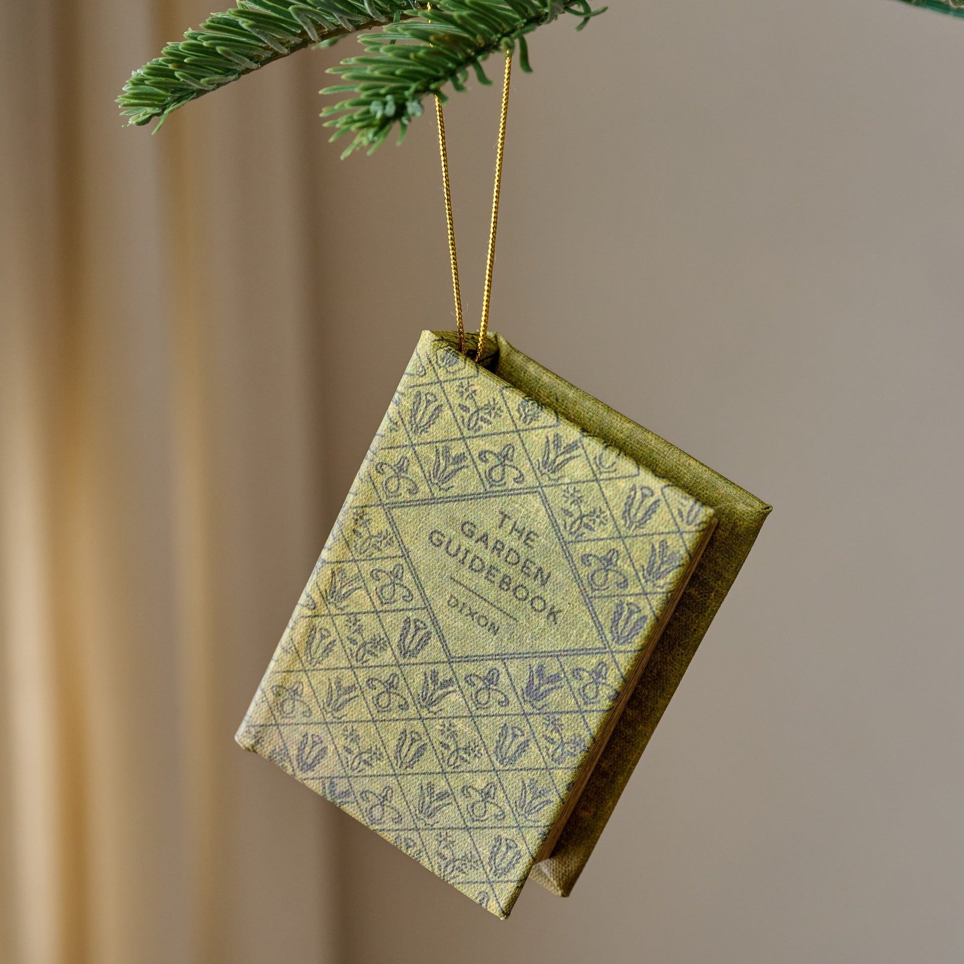 Storybook Ornament shown hung from tree