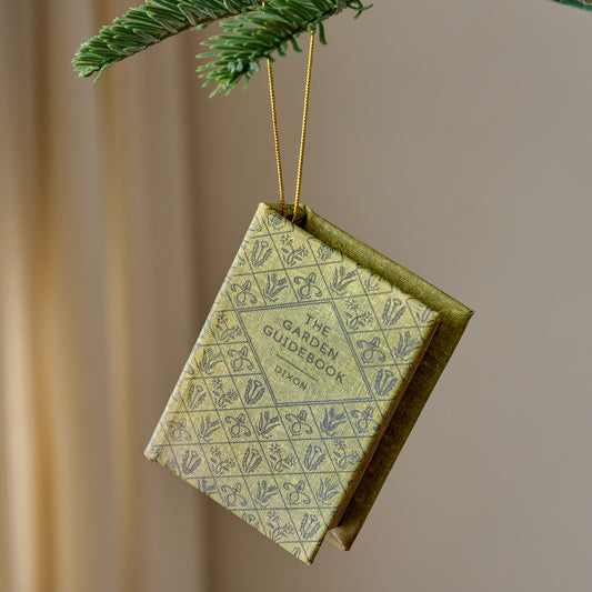 Storybook Ornament shown hung from tree