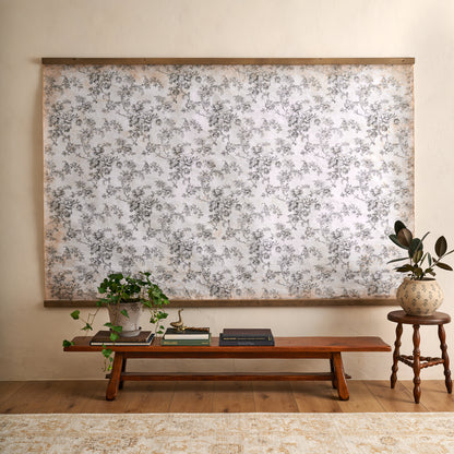 Oversized Heirloom Garden Tapestry in a room with wooden bench coffee table books and greenery plants