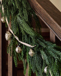 Real Touch Norfolk Pine Garland on a stair rail