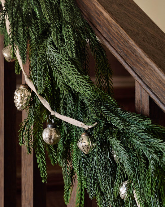 Real Touch Norfolk Pine Garland on a stair rail