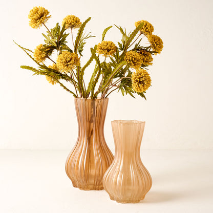 Yellow Large Thistle Bush shown in pink/orange vase next to empty smaller vase nearby