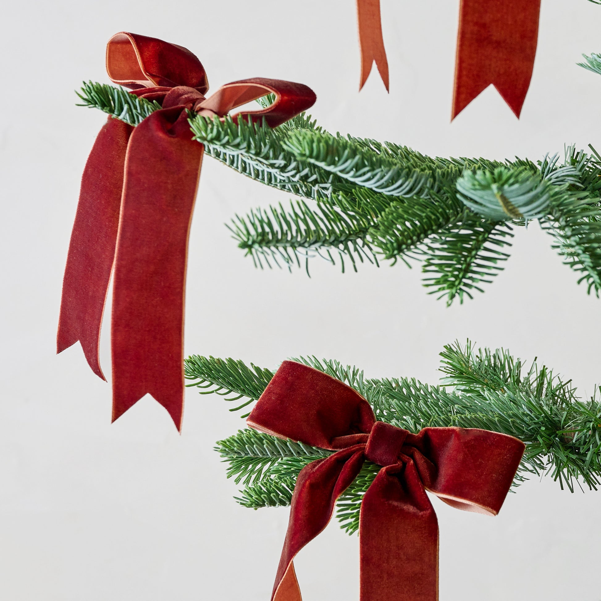 Burgundy Velvet Bow Ornament Clip, Set of 8 shown on tree