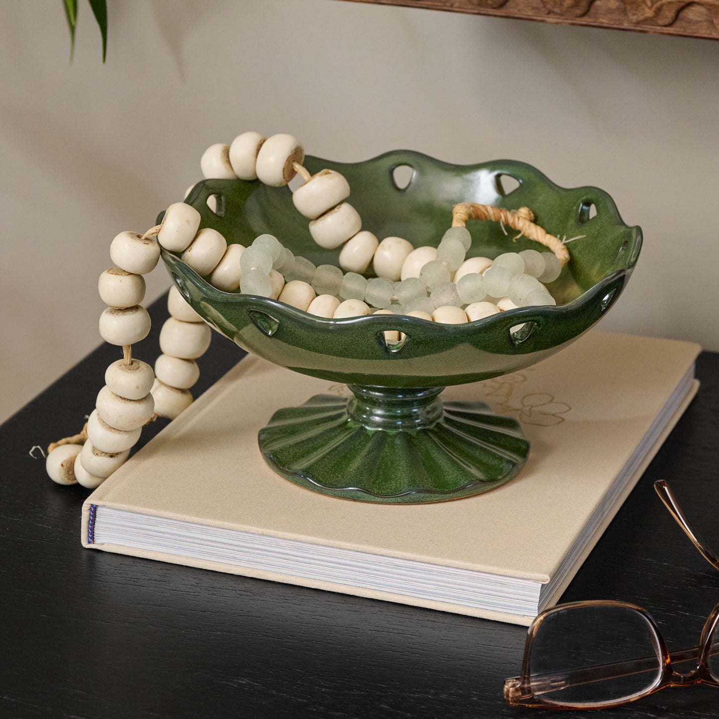 Libby Glazed Ceramic Footed Bowl (large) with decorative accents on top of coffee table book