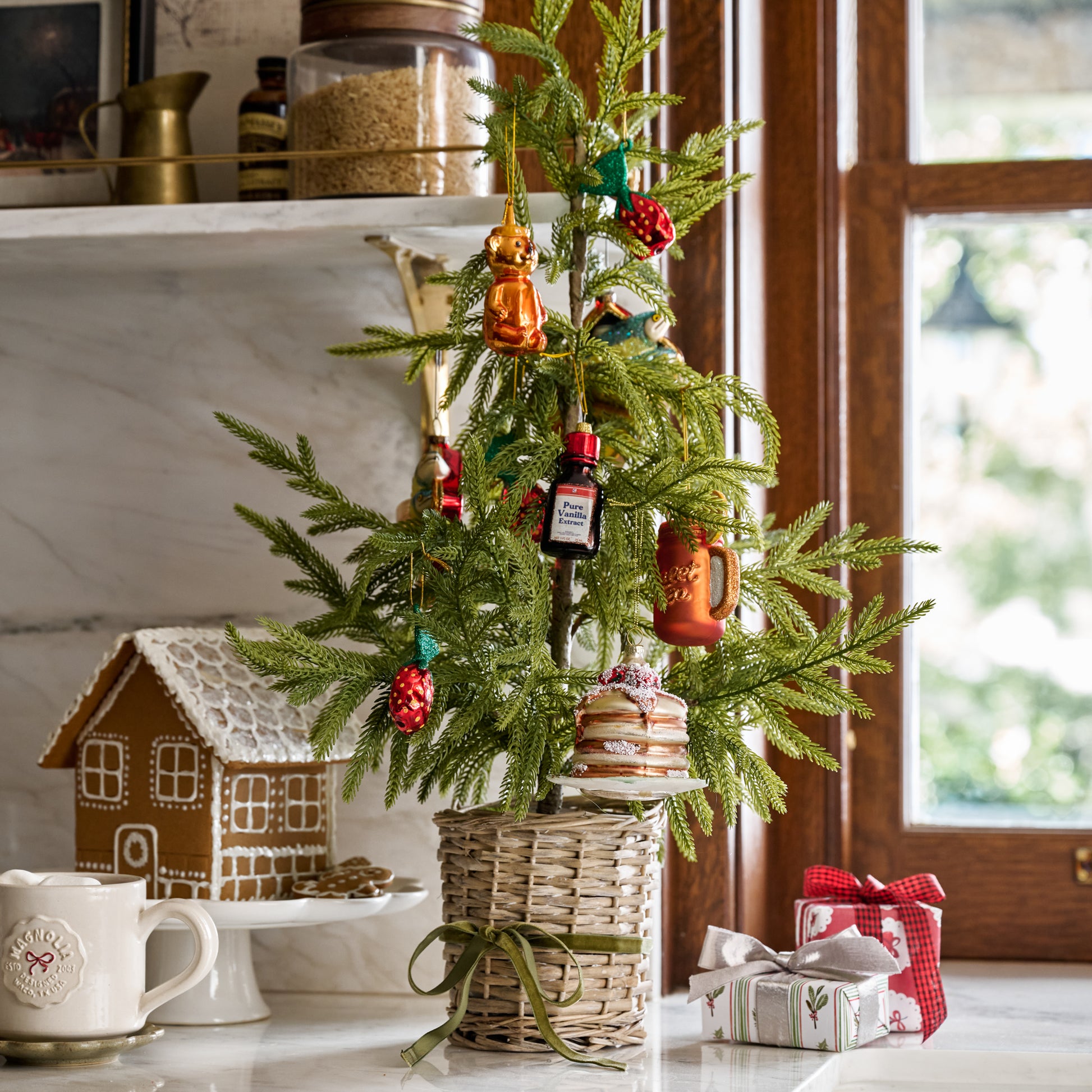 Real Touch Norfolk Pine Potted Tree shown on kitchen counter with ornaments