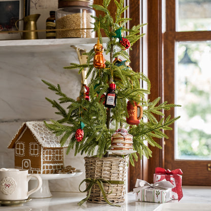 Real Touch Norfolk Pine Potted Tree shown on kitchen counter with ornaments