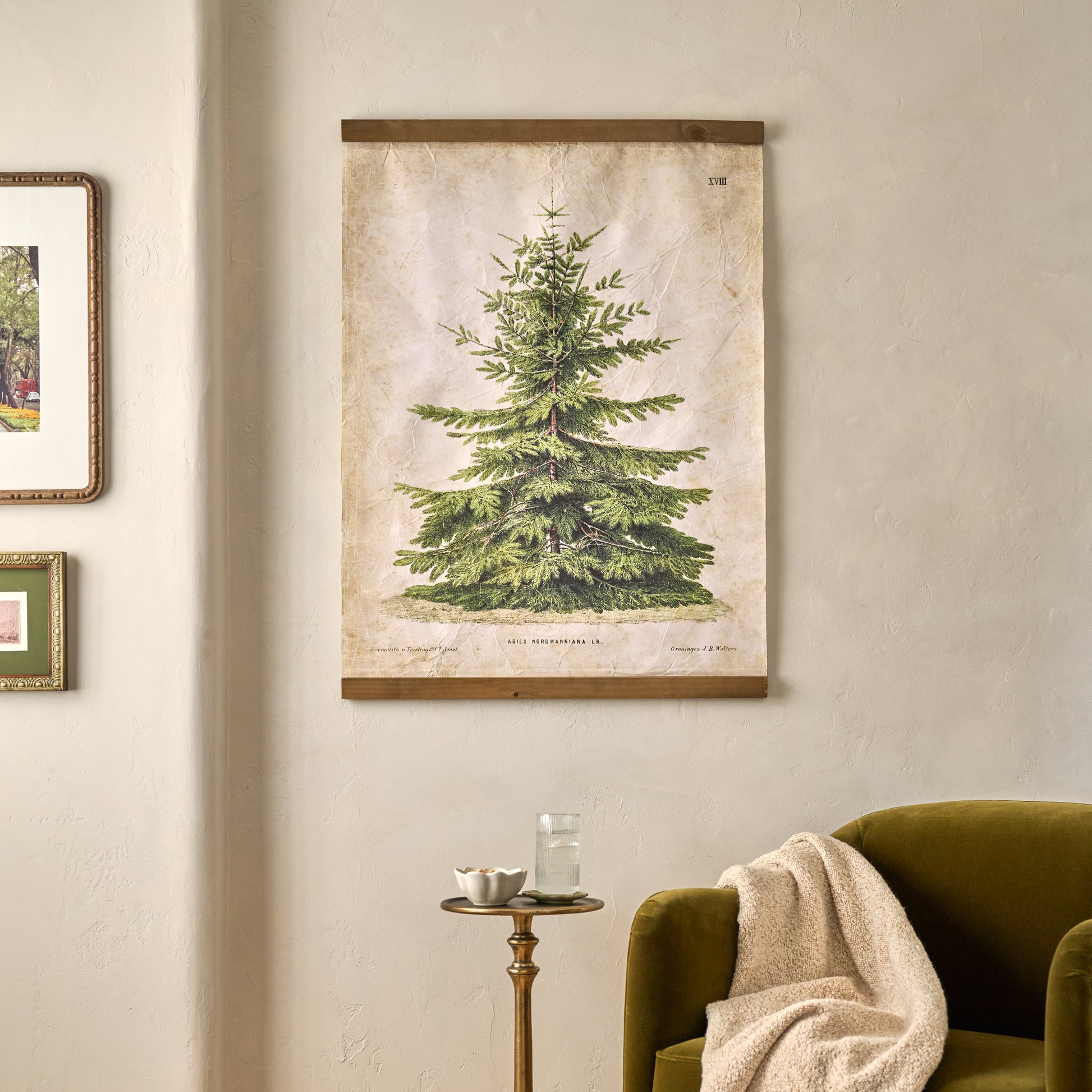 Vintage Christmas Fir Tapestry shown hung on wall above accent chair