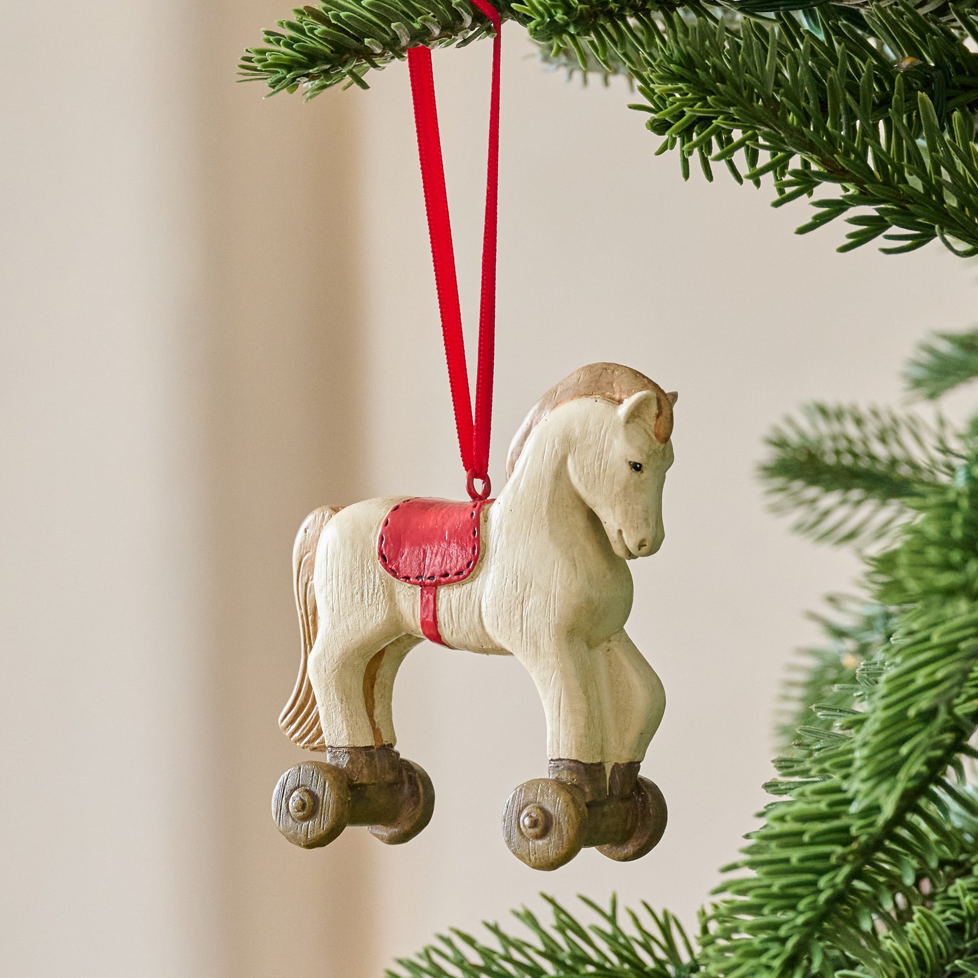 Vintage-Inspired Rocking Horse Ornament shown hung from tree