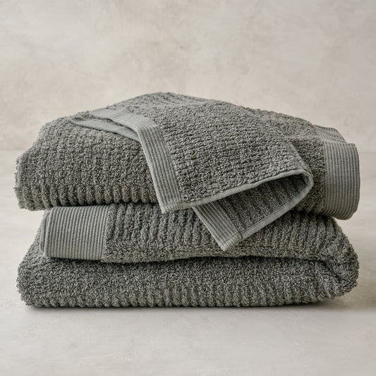 stacked olive green Textured bath towels and washcloth