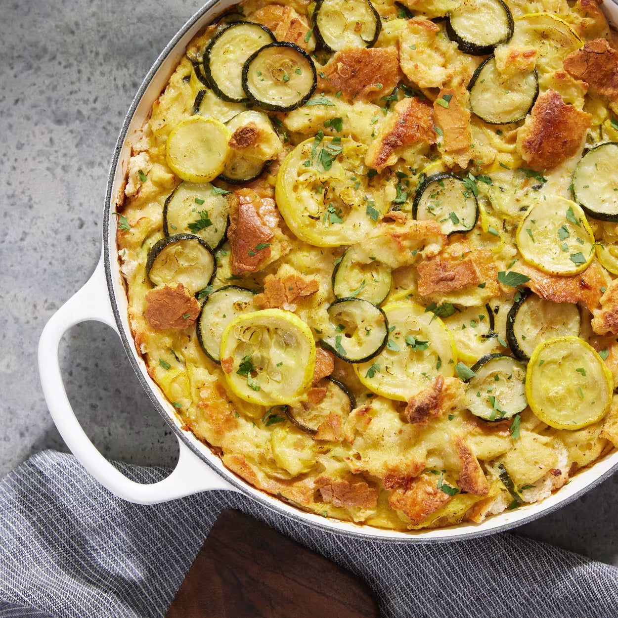 Opened Dutch oven with zucchini and squash strata inside.