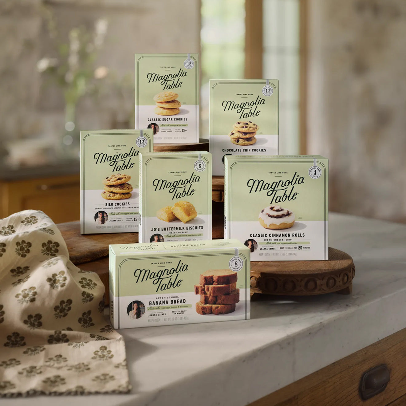 Collection of Magnolia Table product packages on a kitchen counter.