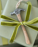 #DEMODAY Hammer Ornament shown attached to gift